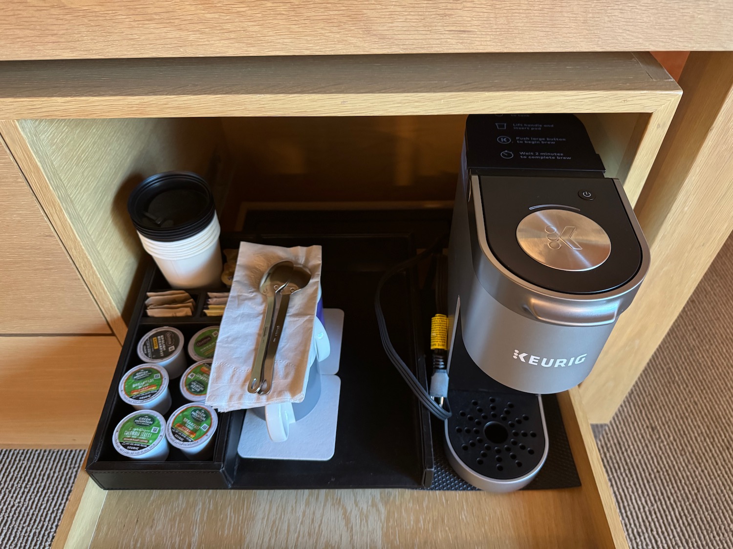 a coffee machine and cups in a drawer