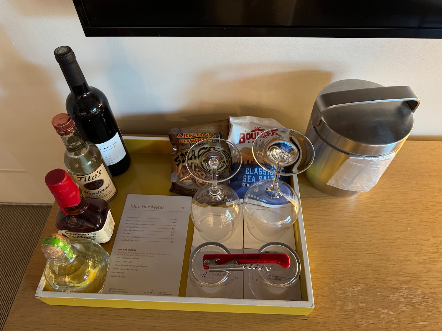 a tray with wine glasses and bottles