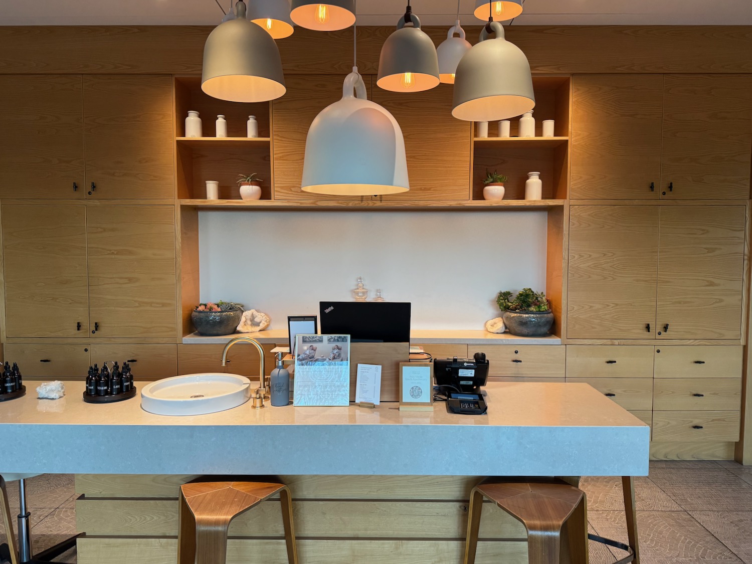 a counter with a sink and stools