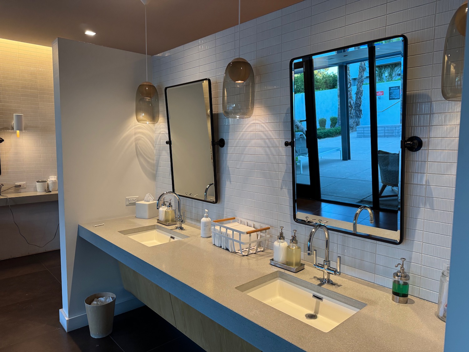 a bathroom with sinks and mirrors