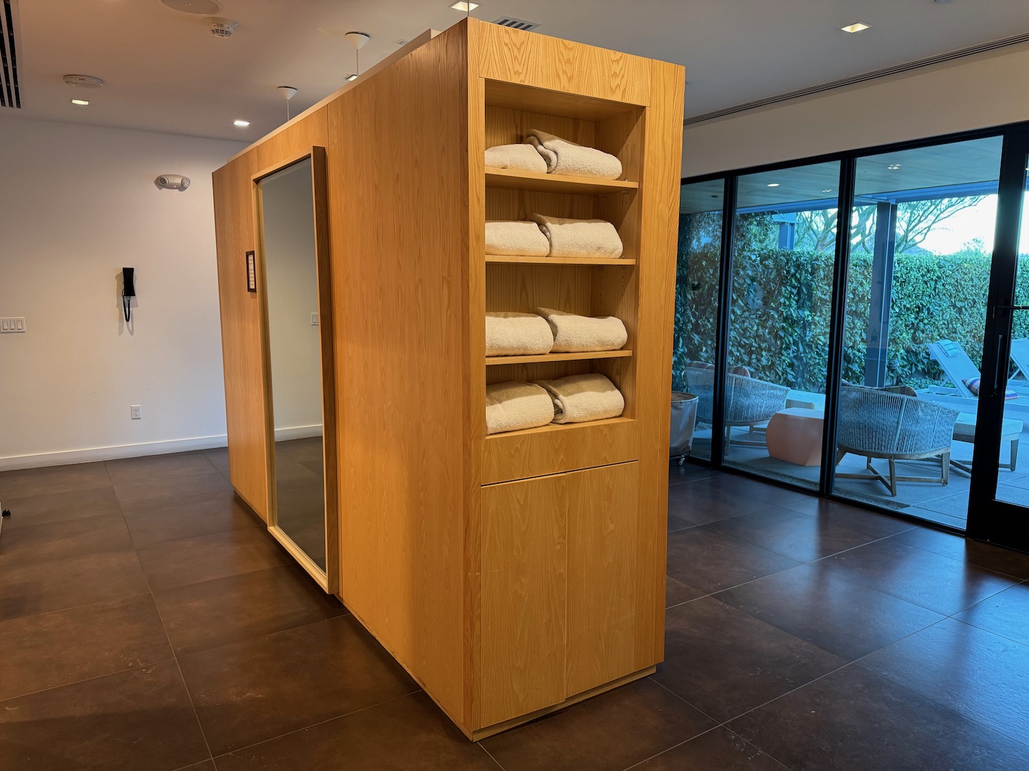 a wooden shelf with towels on it