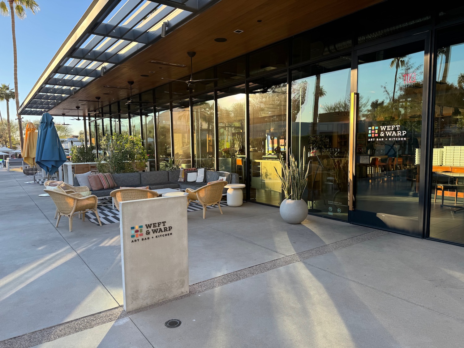 a building with a glass wall and a patio