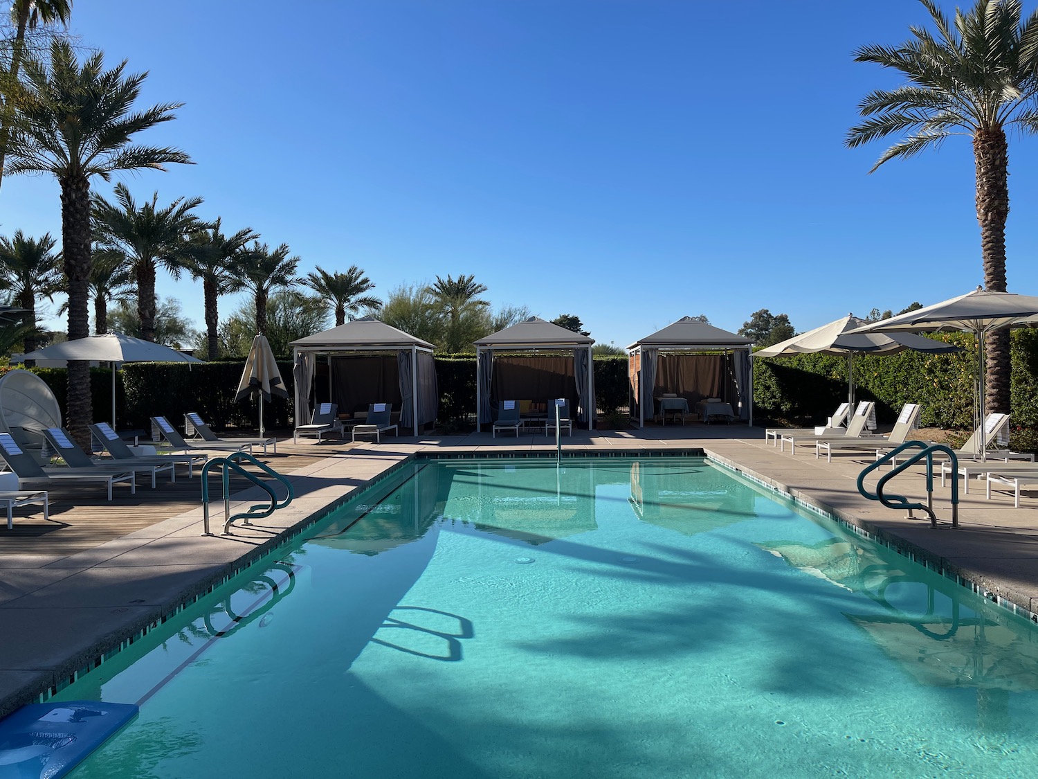 a pool with umbrellas and chairs