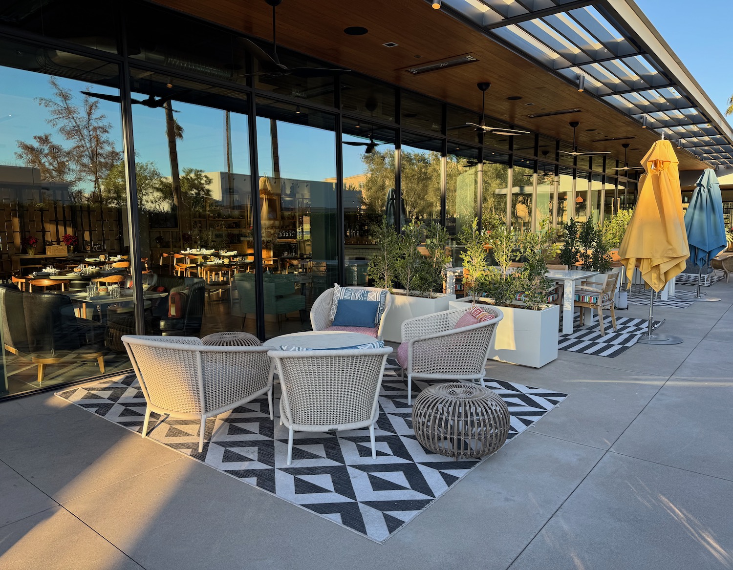 a patio with chairs and tables