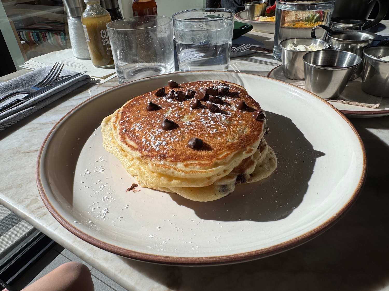 a plate of pancakes with chocolate chips on it