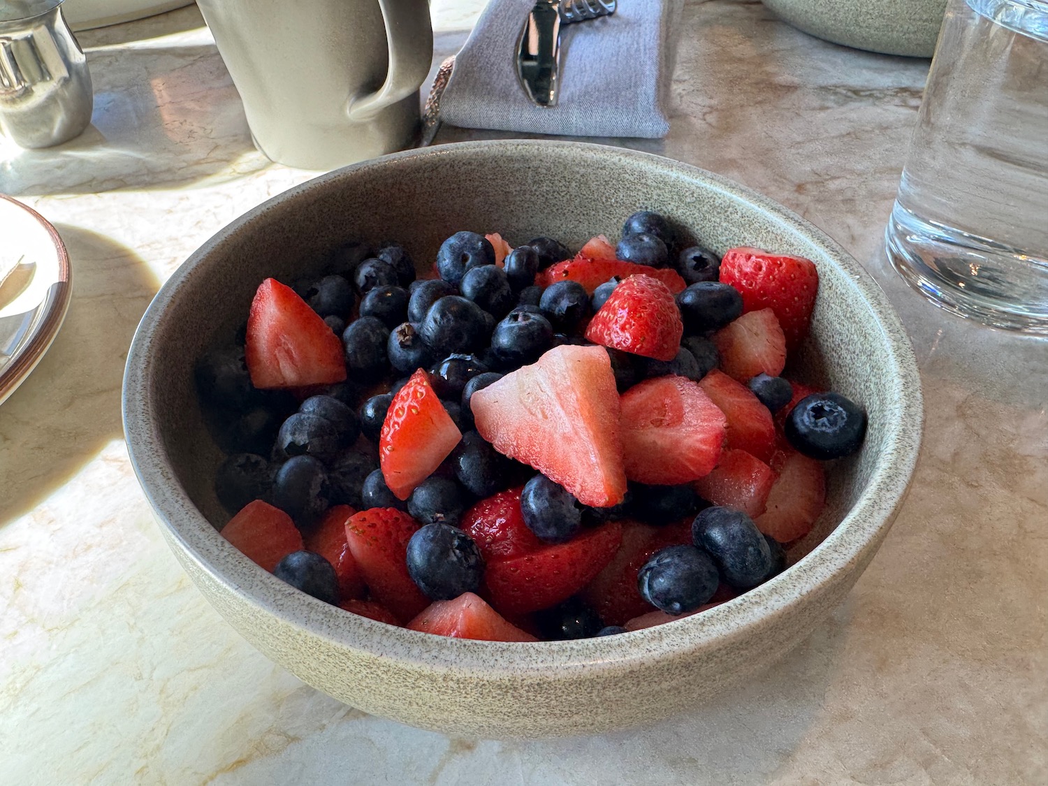 a bowl of fruit on a table