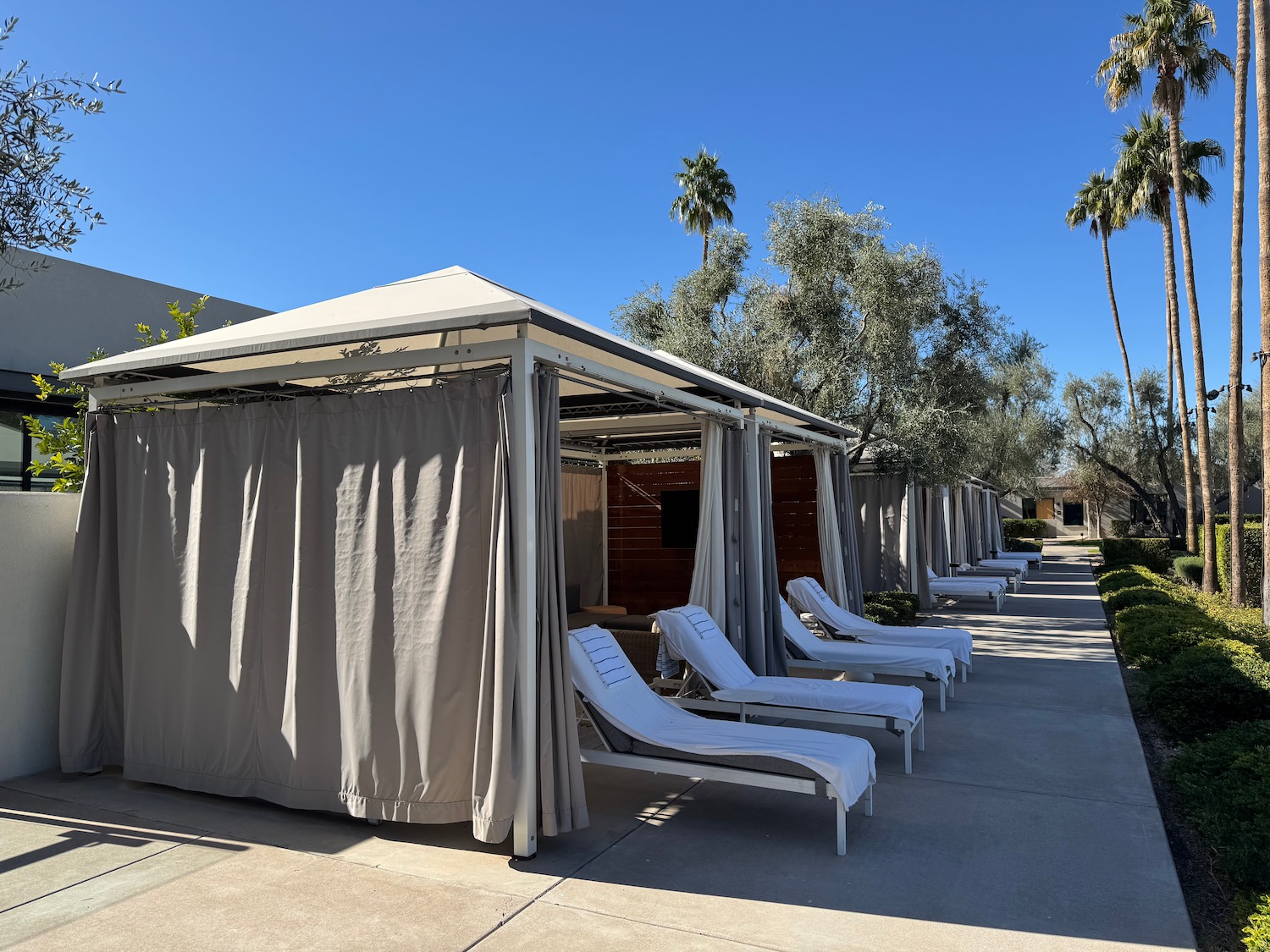 a row of lounge chairs and a tent