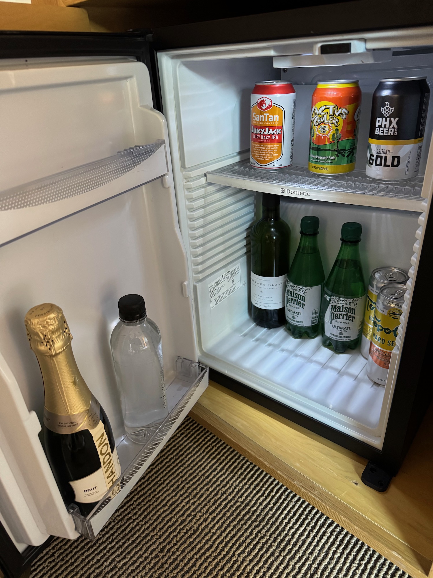 a refrigerator with bottles of beer and cans of alcohol