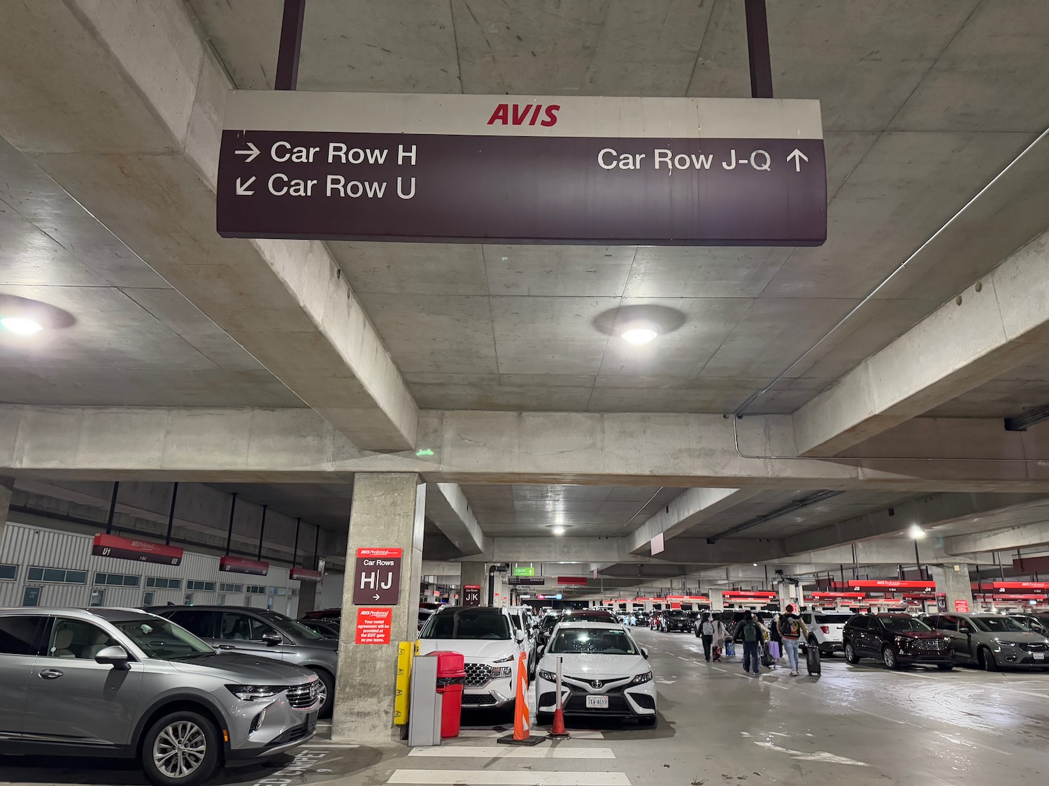 a parking garage with cars and people