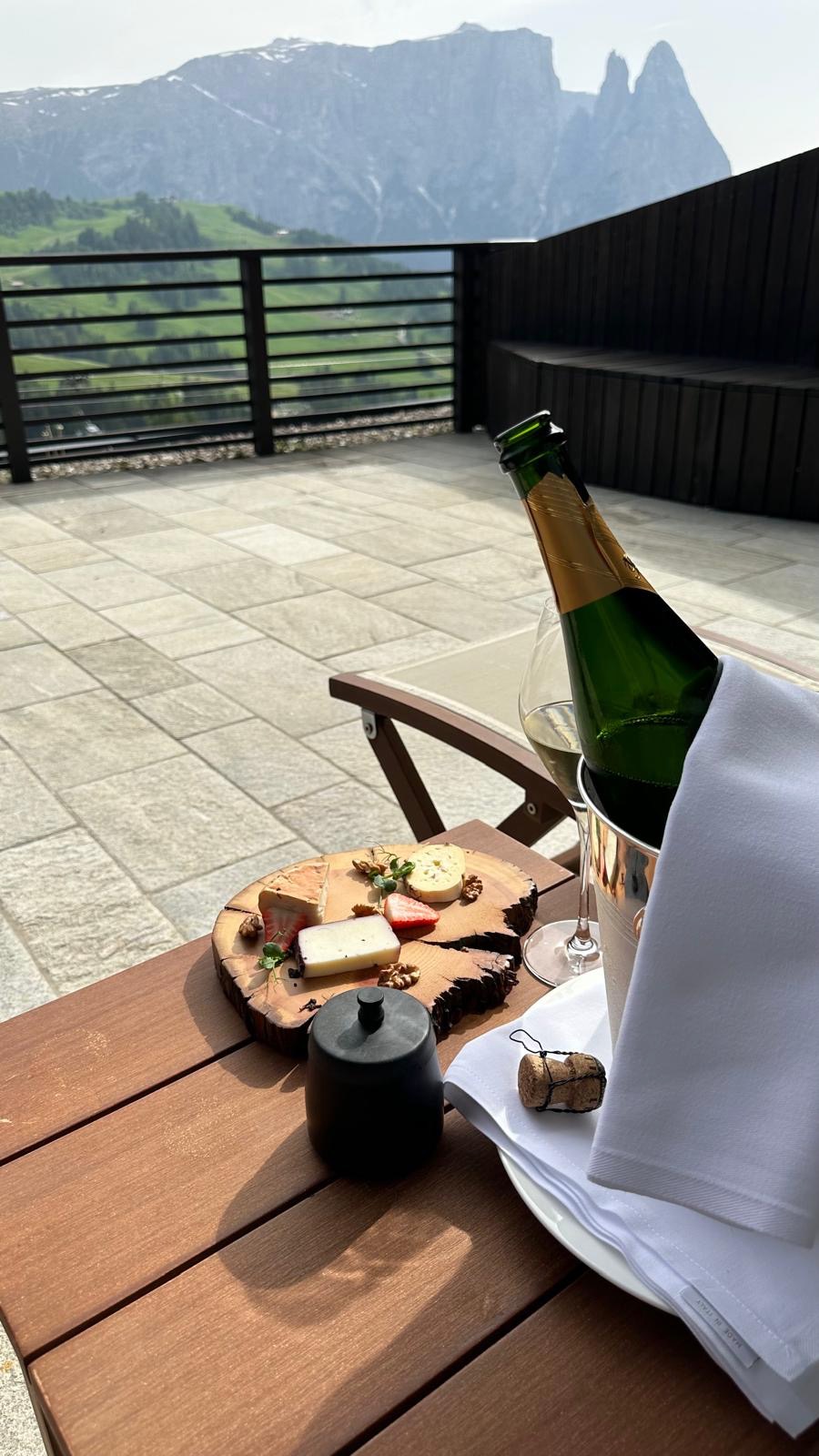 a bottle of wine and a plate of food on a table