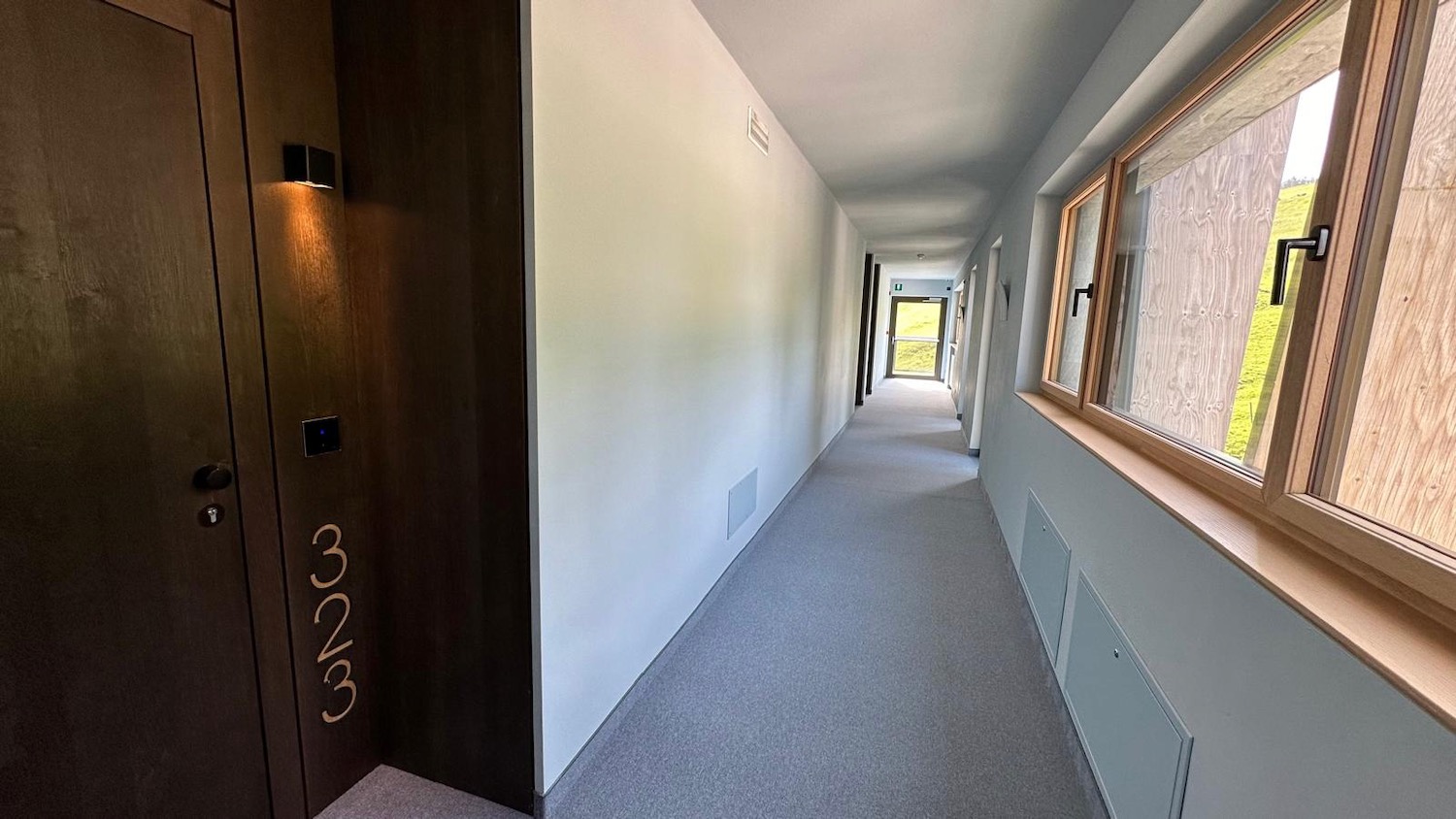 a hallway with a door and windows