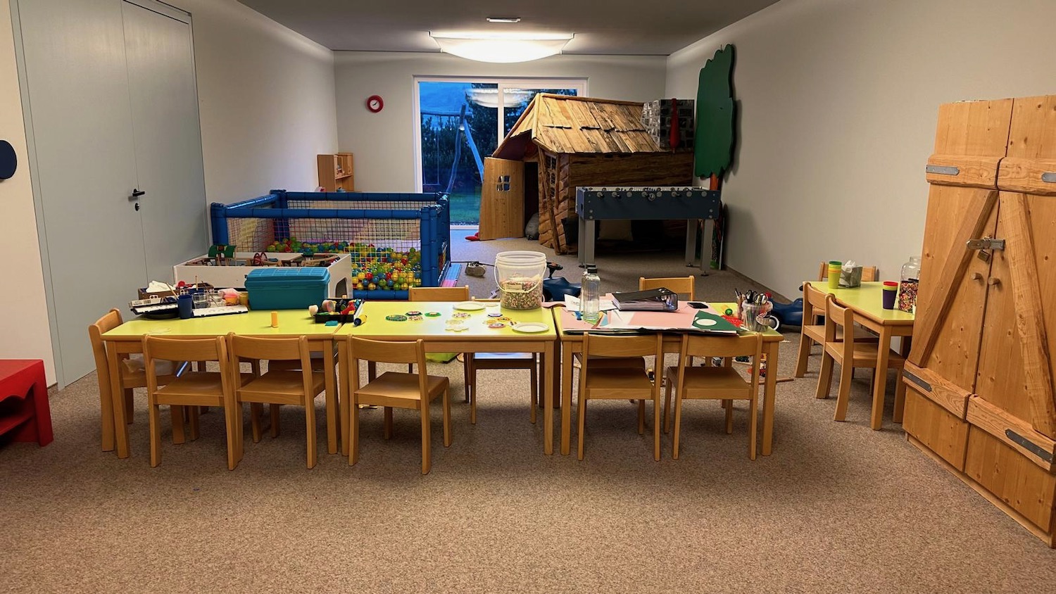 a room with a table and chairs and toys