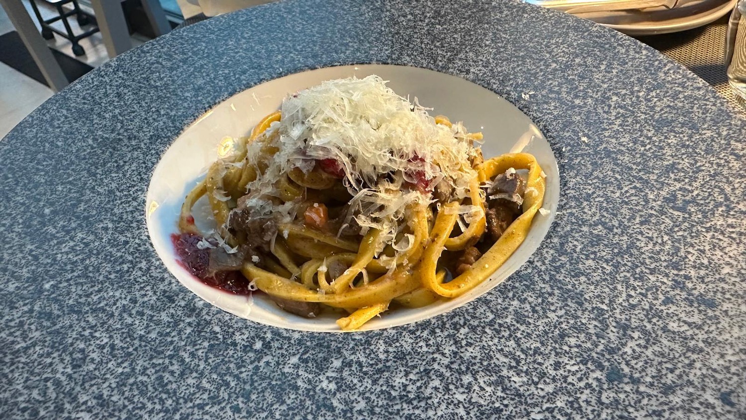 a plate of pasta with grated cheese