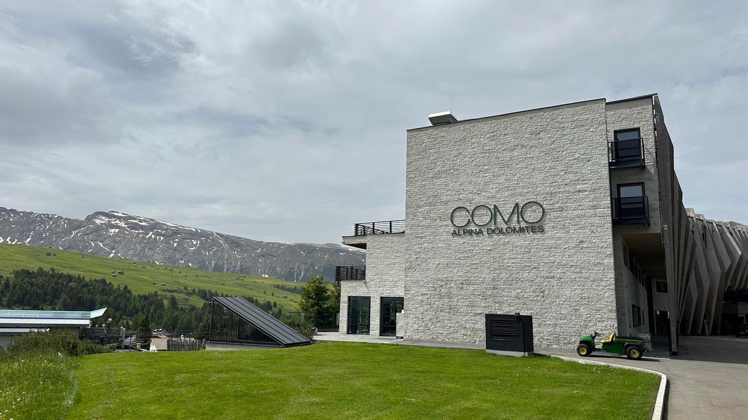 a building with a green lawn and a motorcycle