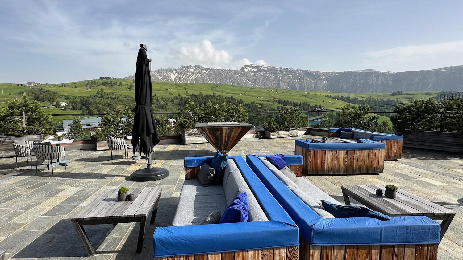 a patio with a view of mountains and trees