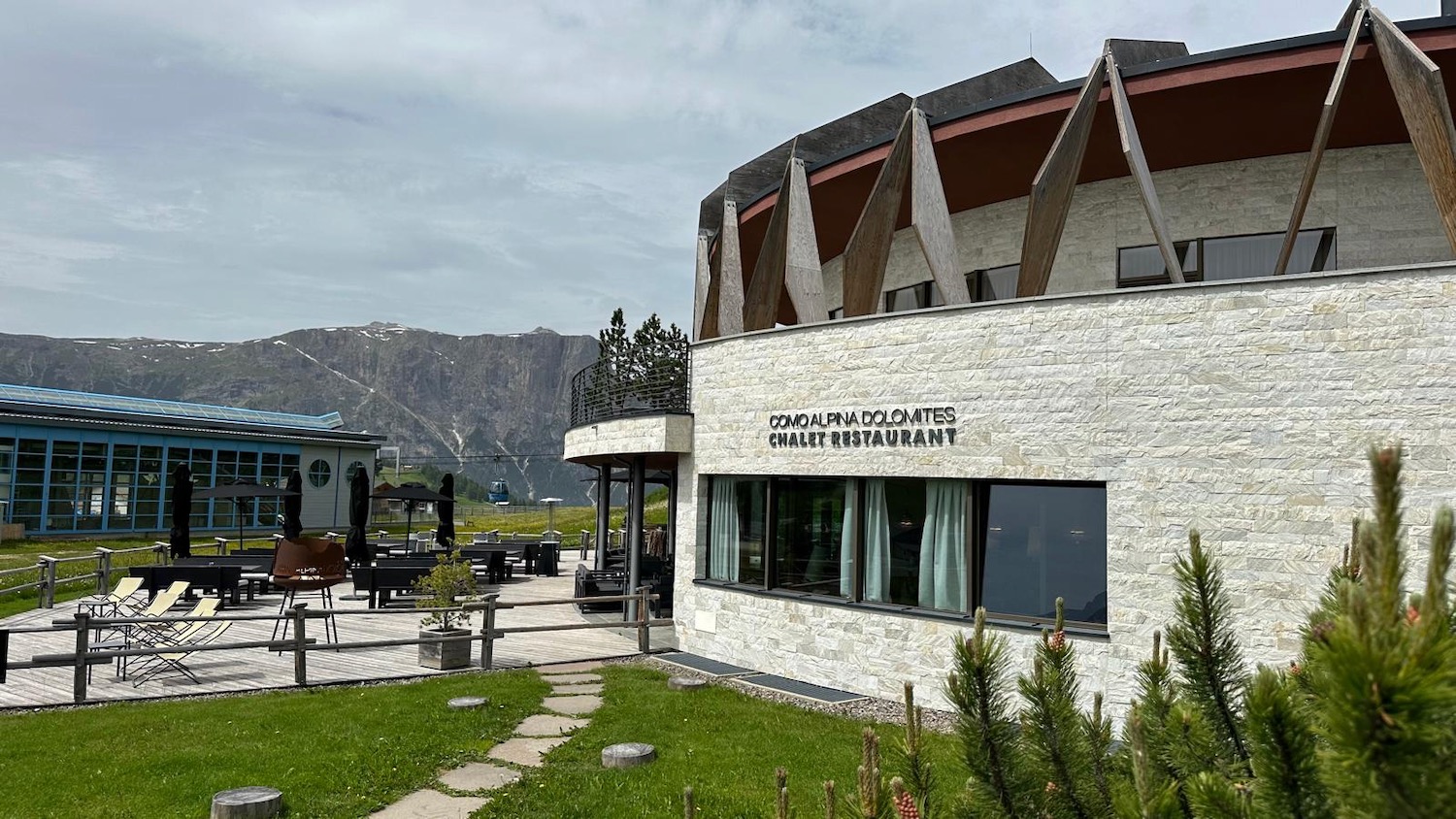 a building with a stone wall and a stone patio