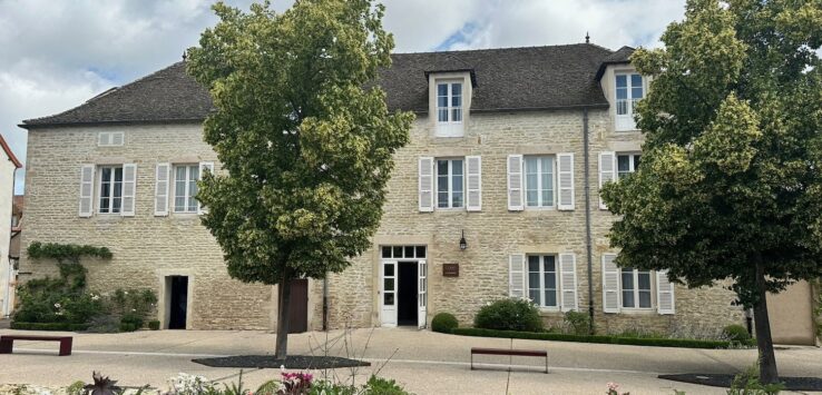 a building with trees and a bench