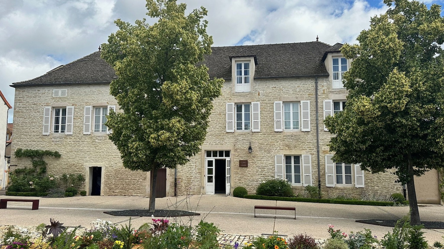 a building with trees and a bench