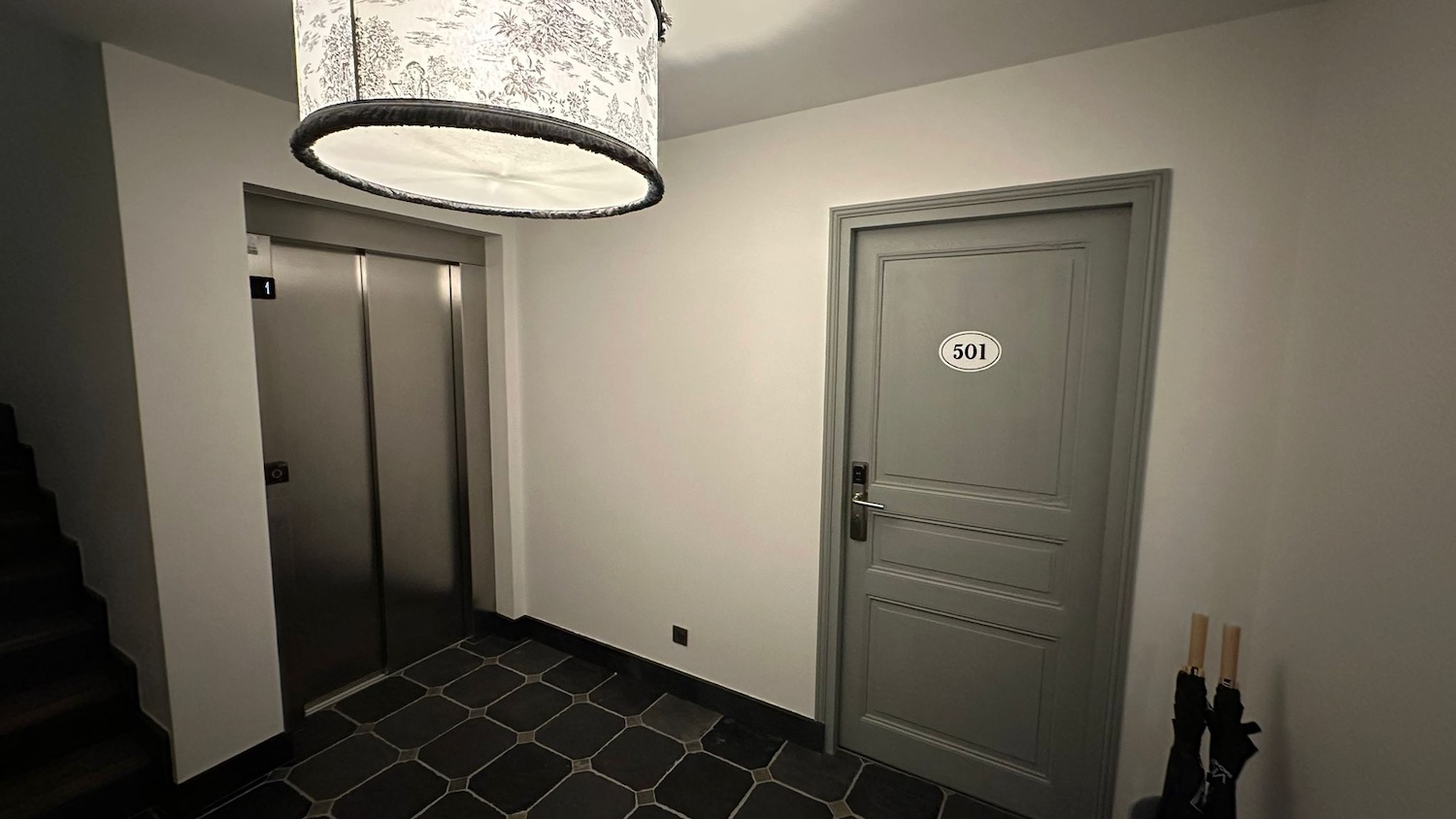 a room with two elevators and a grey door