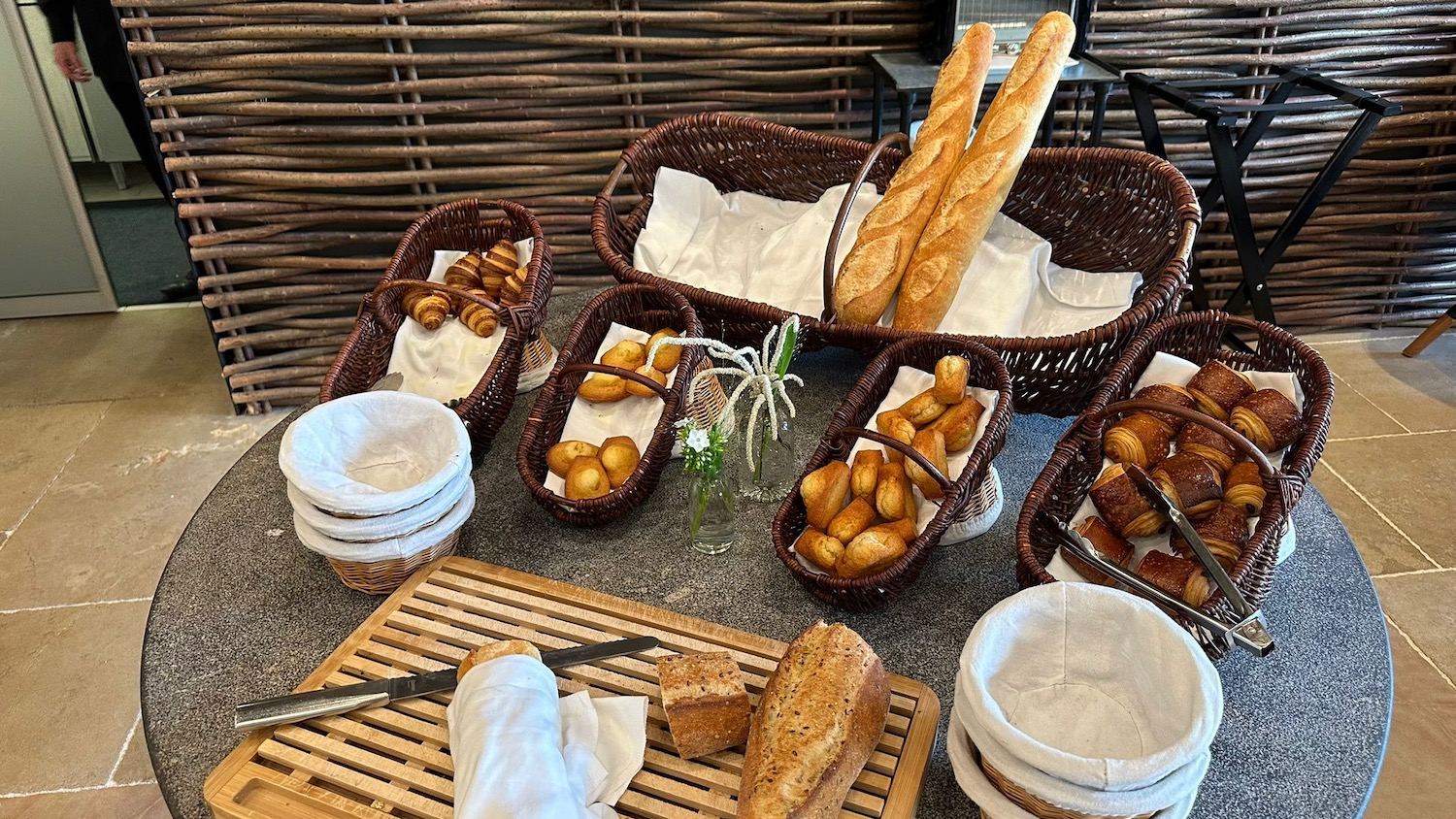 a table with baskets of bread