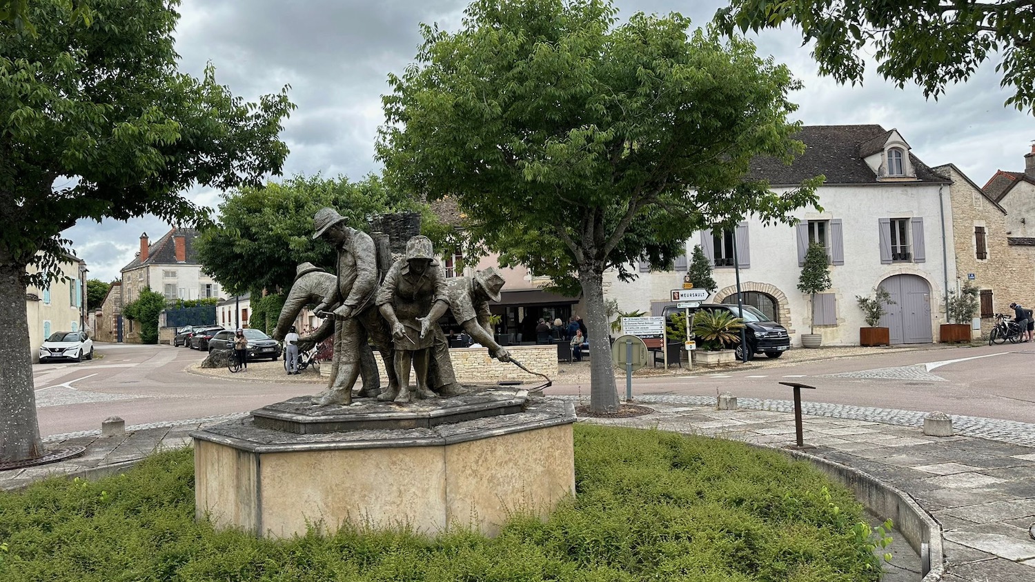 a statue of a group of people in a park