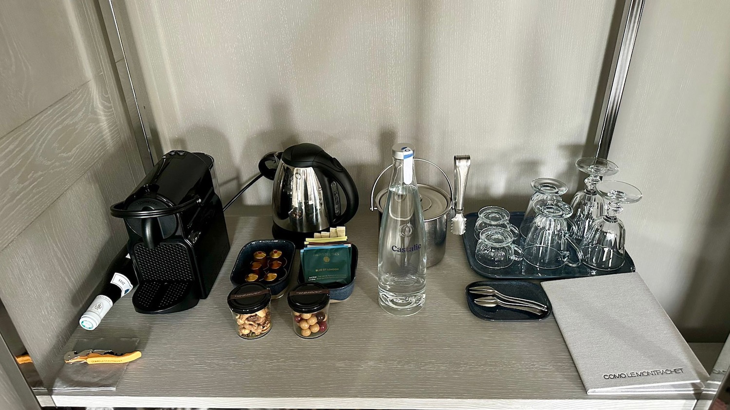 a table with coffee maker and glasses