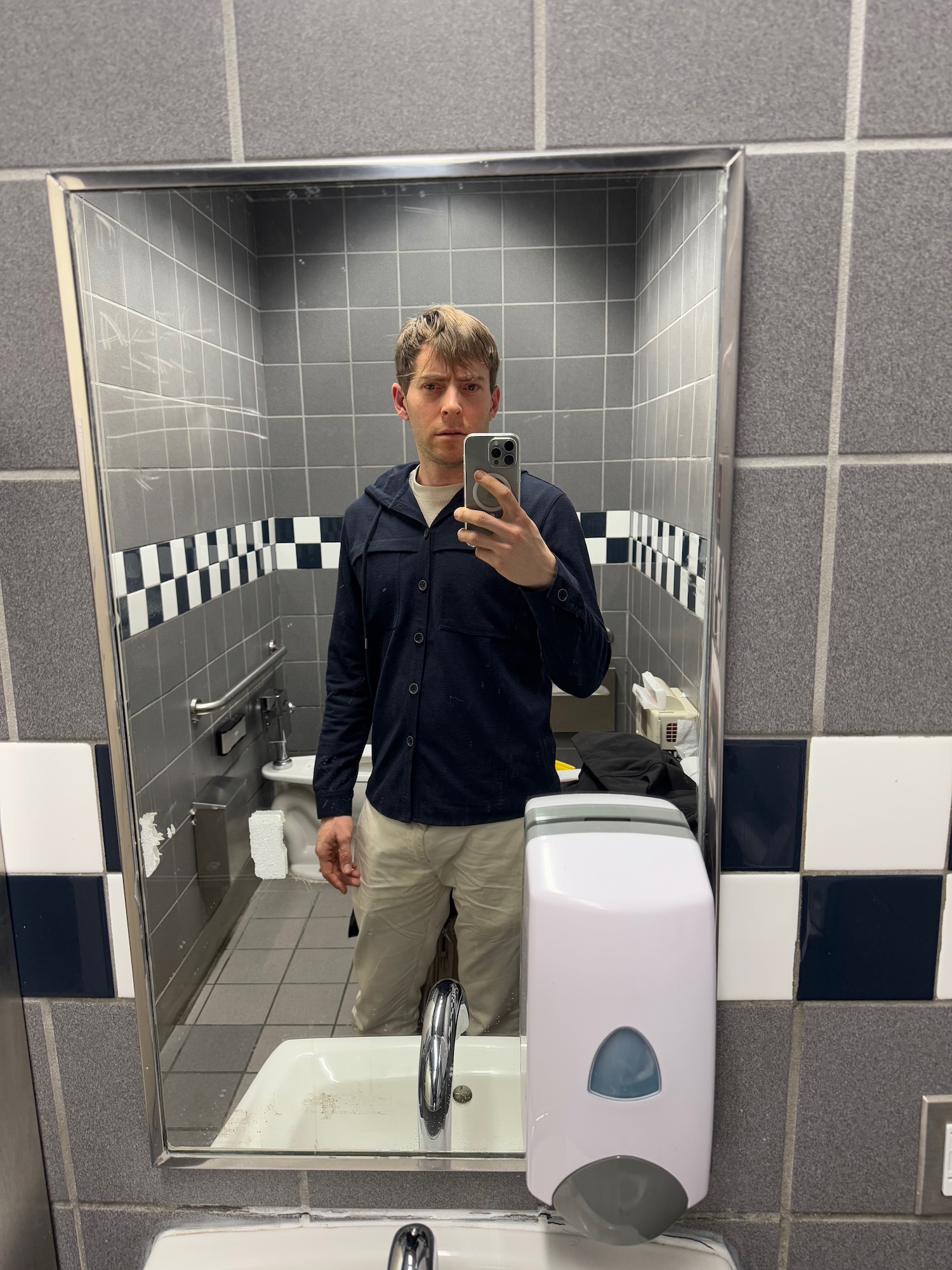 a man taking a selfie in a bathroom