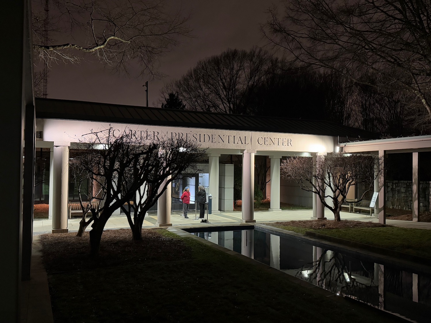 a building with columns and a pool