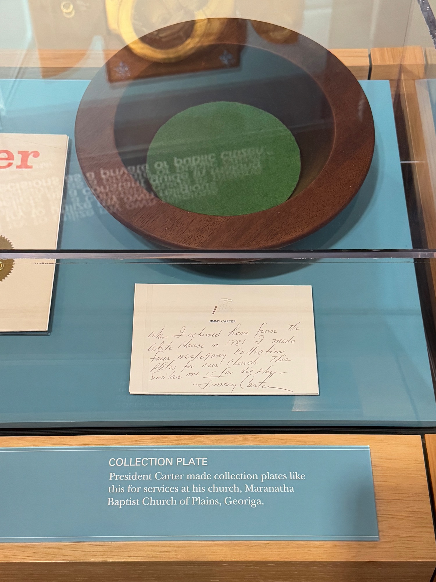 a plate and note in a glass case