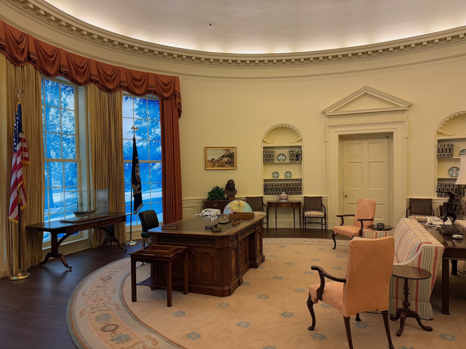 a room with a desk and chairs