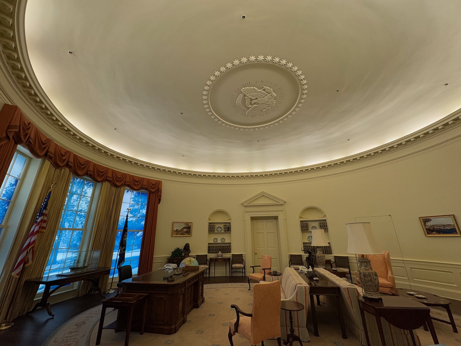 a room with a round ceiling and a large window