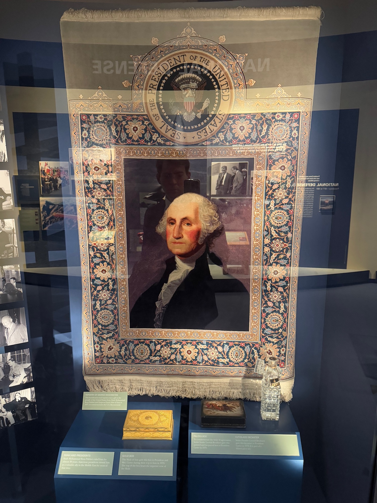 a framed picture of a man in a blue and white rug