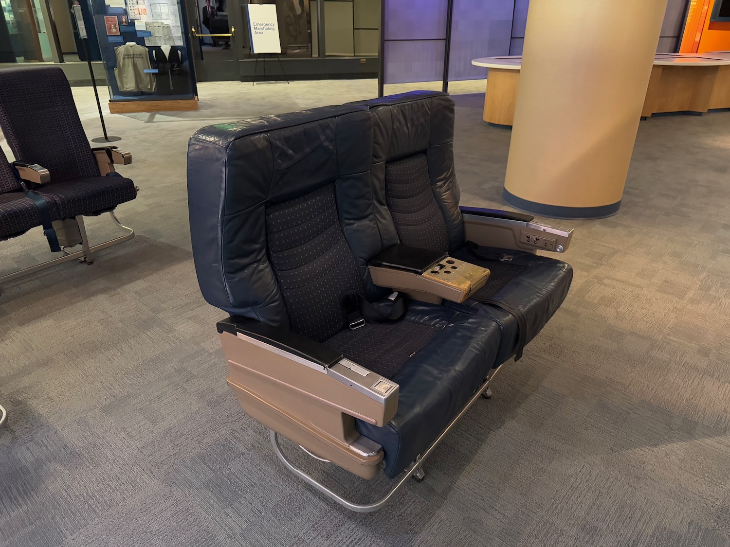 a black leather chair with a rectangular object on the back