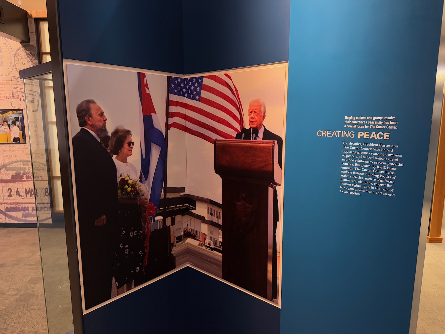 a poster of a man standing at a podium with a flag