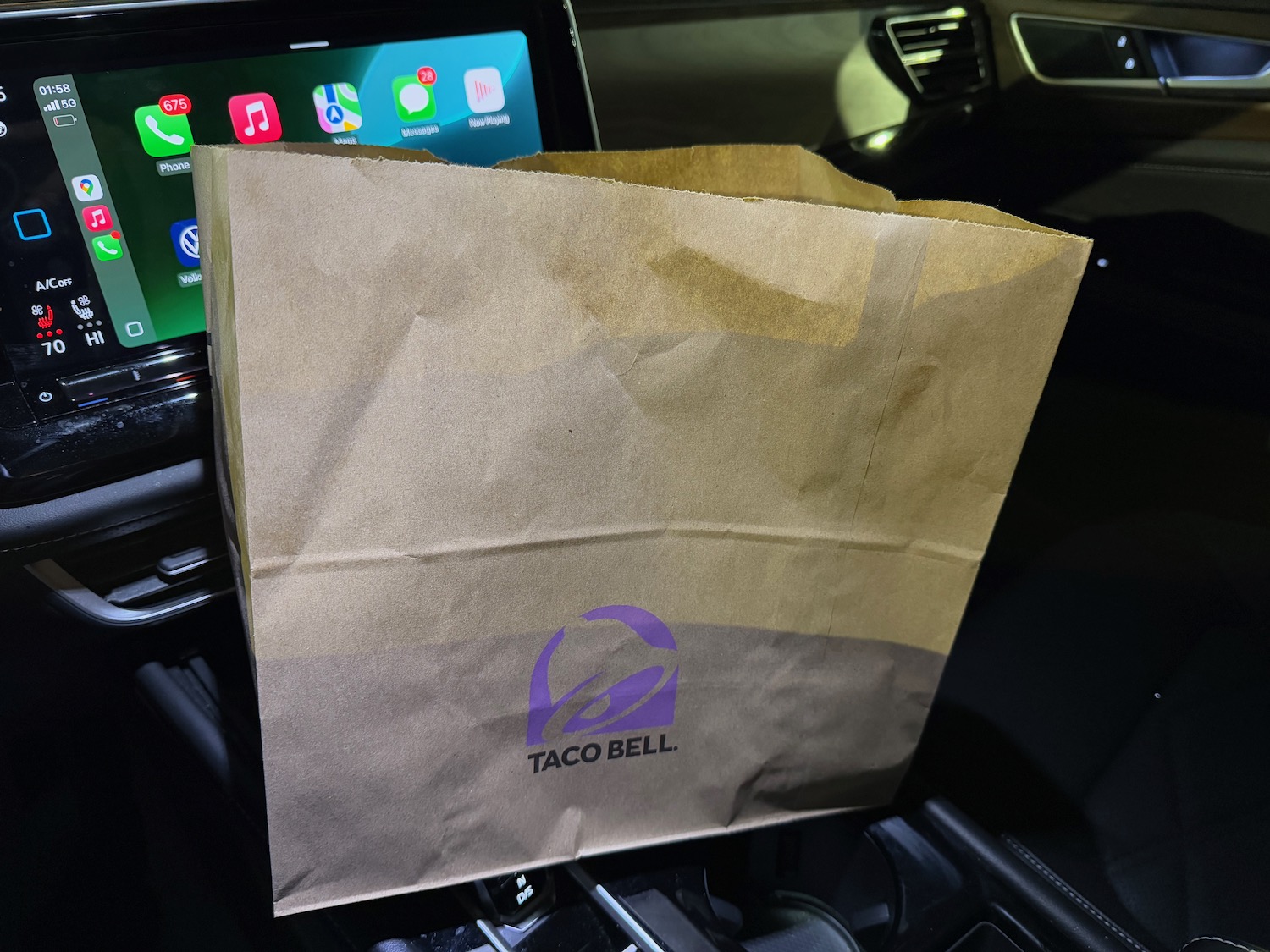 a brown bag on a car dashboard