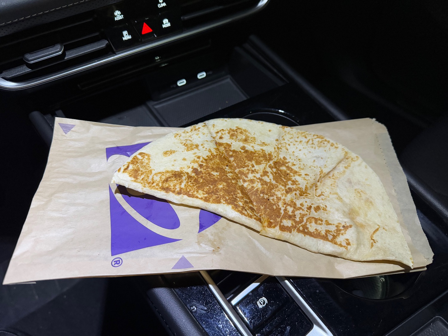 a tortilla on a paper bag in a car