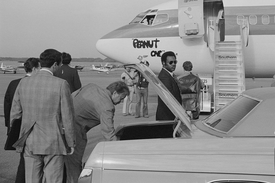 a group of men getting into a car