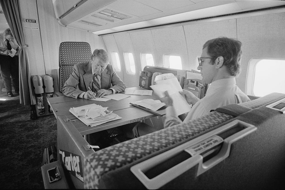 a man sitting at a desk with papers on it