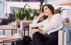 a woman sitting in a chair with luggage