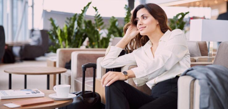 a woman sitting in a chair with luggage