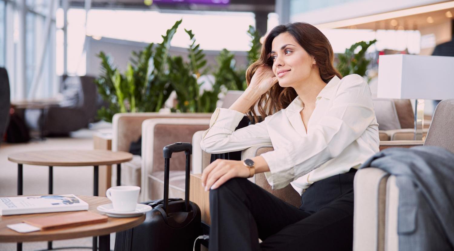 a woman sitting in a chair with luggage