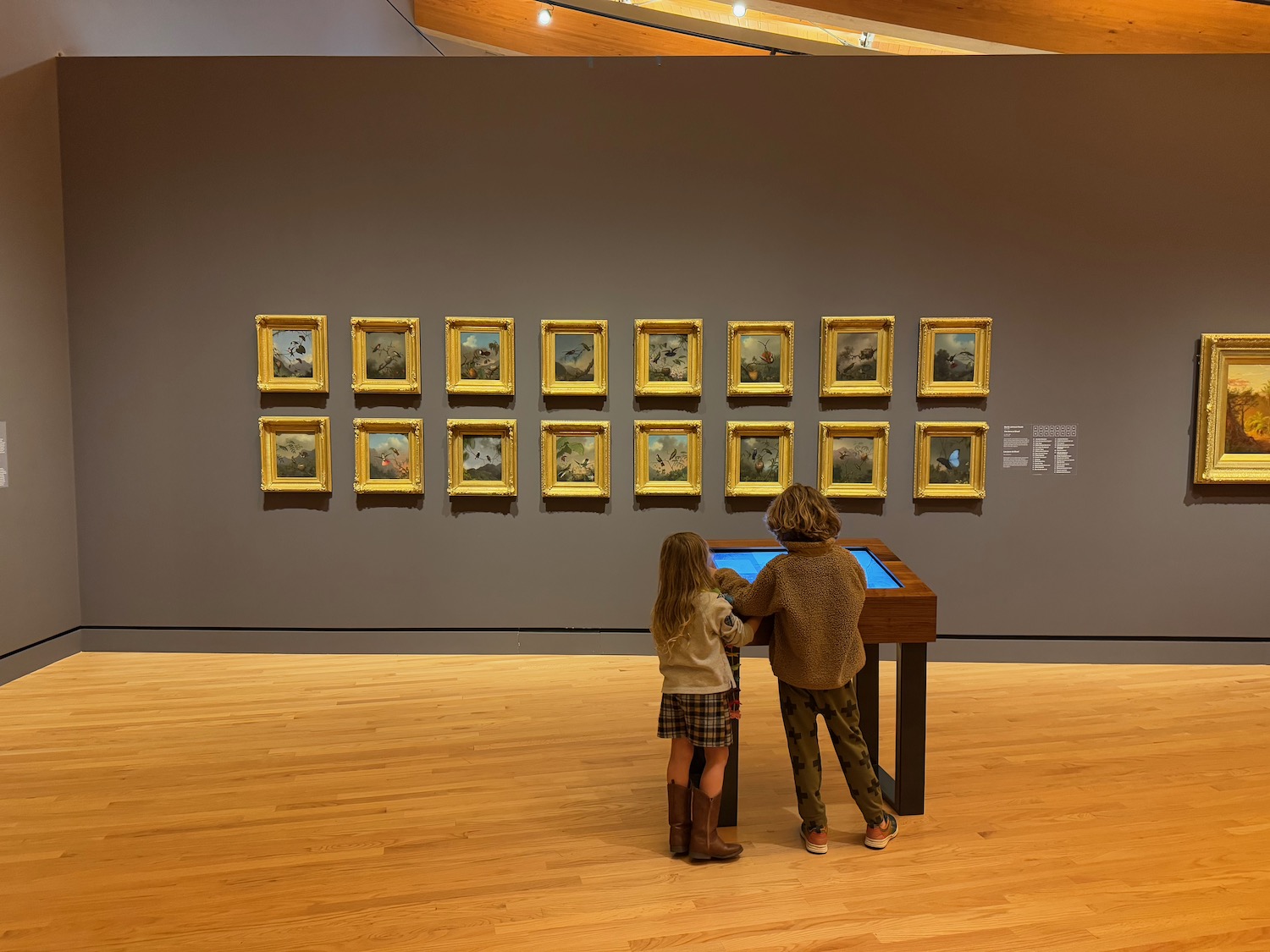 two children looking at a display