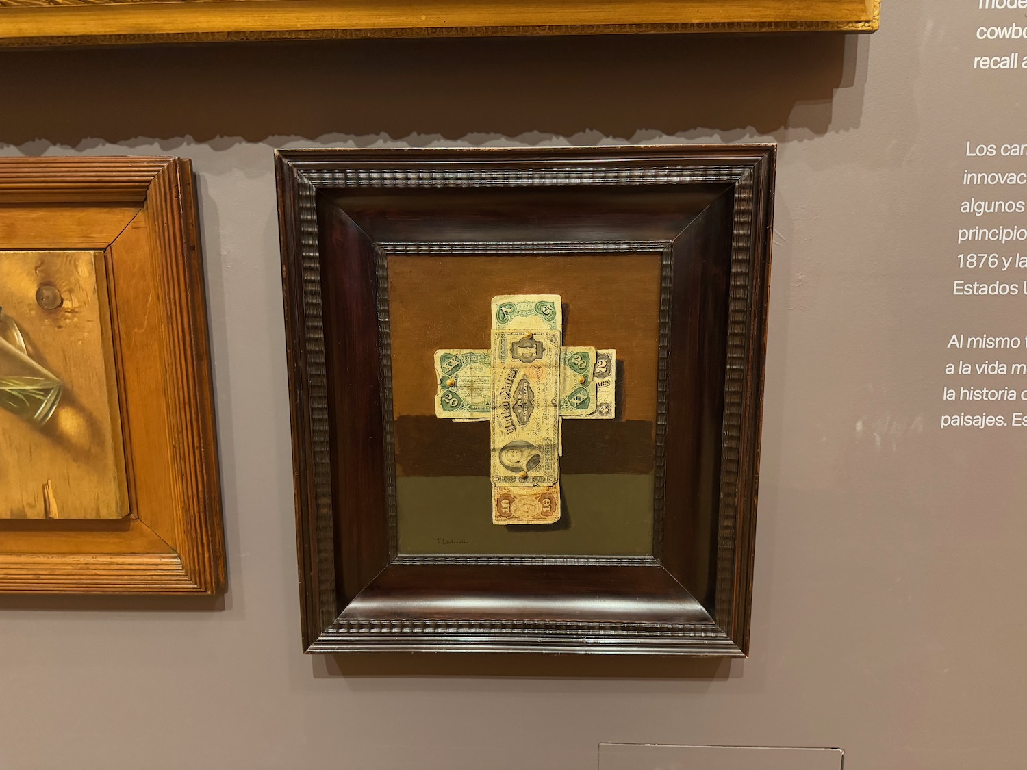 a framed picture of a cross on a wall