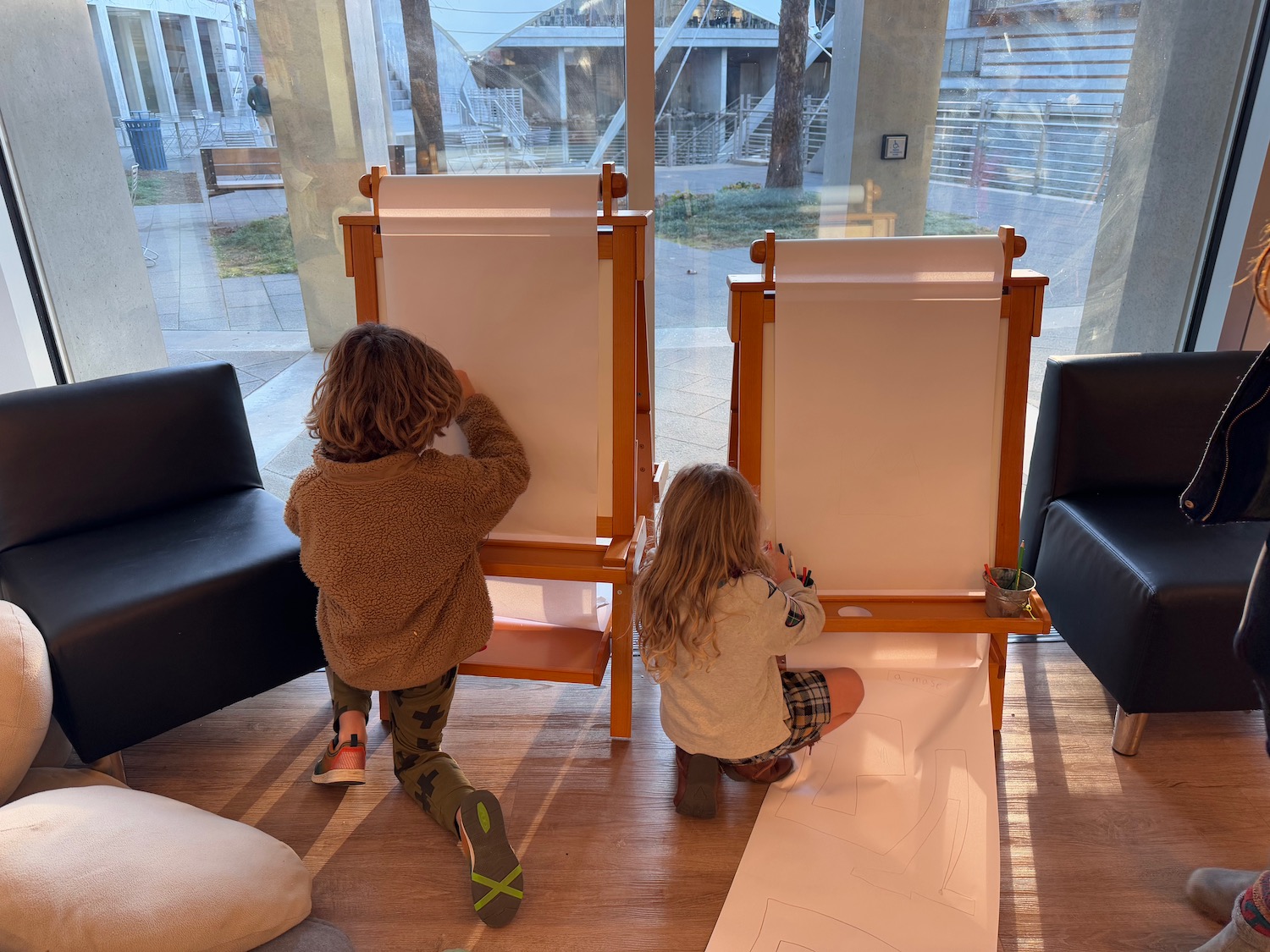 two children drawing on a paper