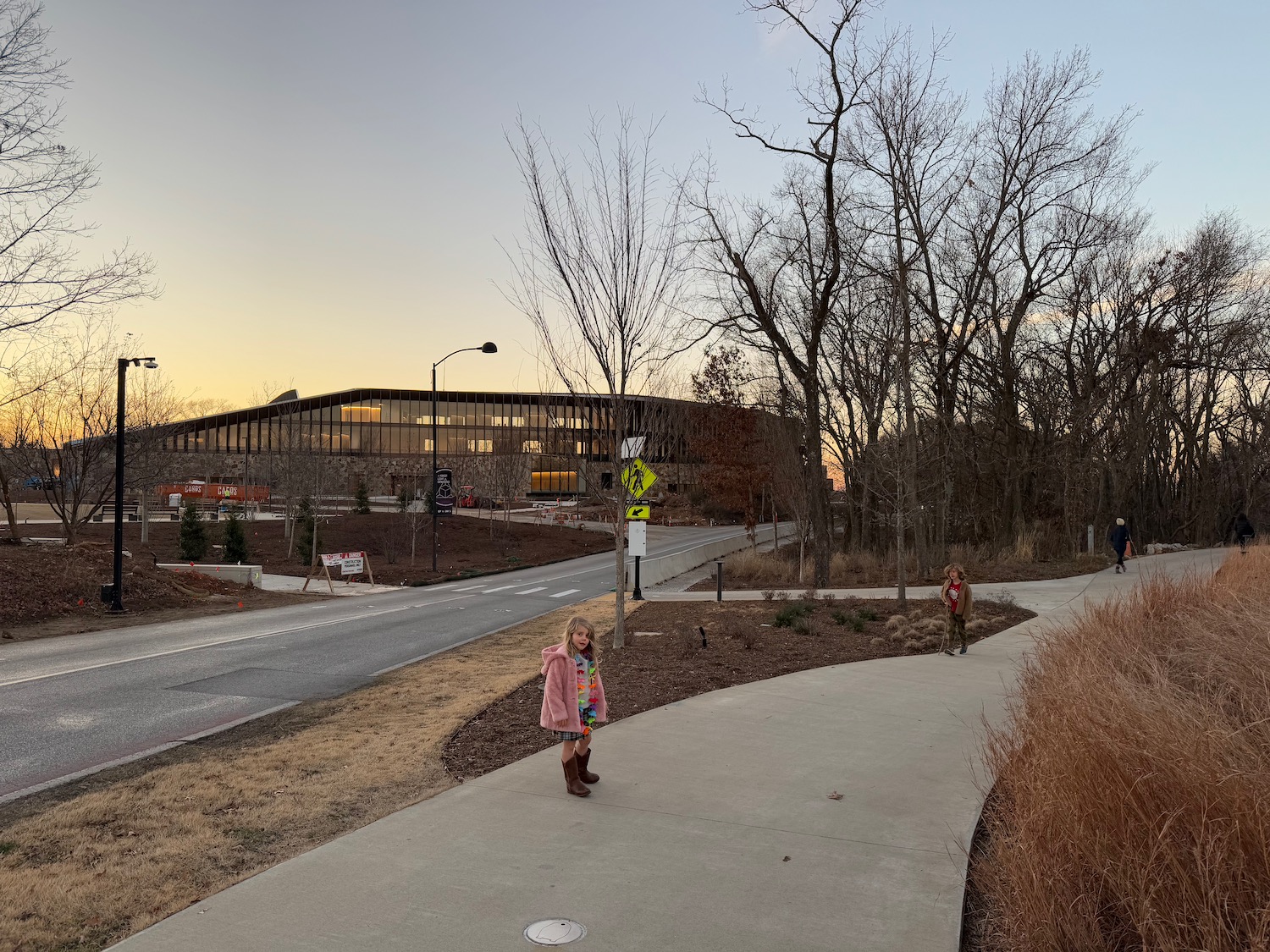 two children walking on a sidewalk