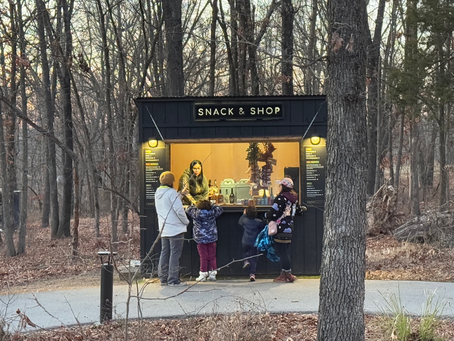 a group of people standing in front of a snack stand