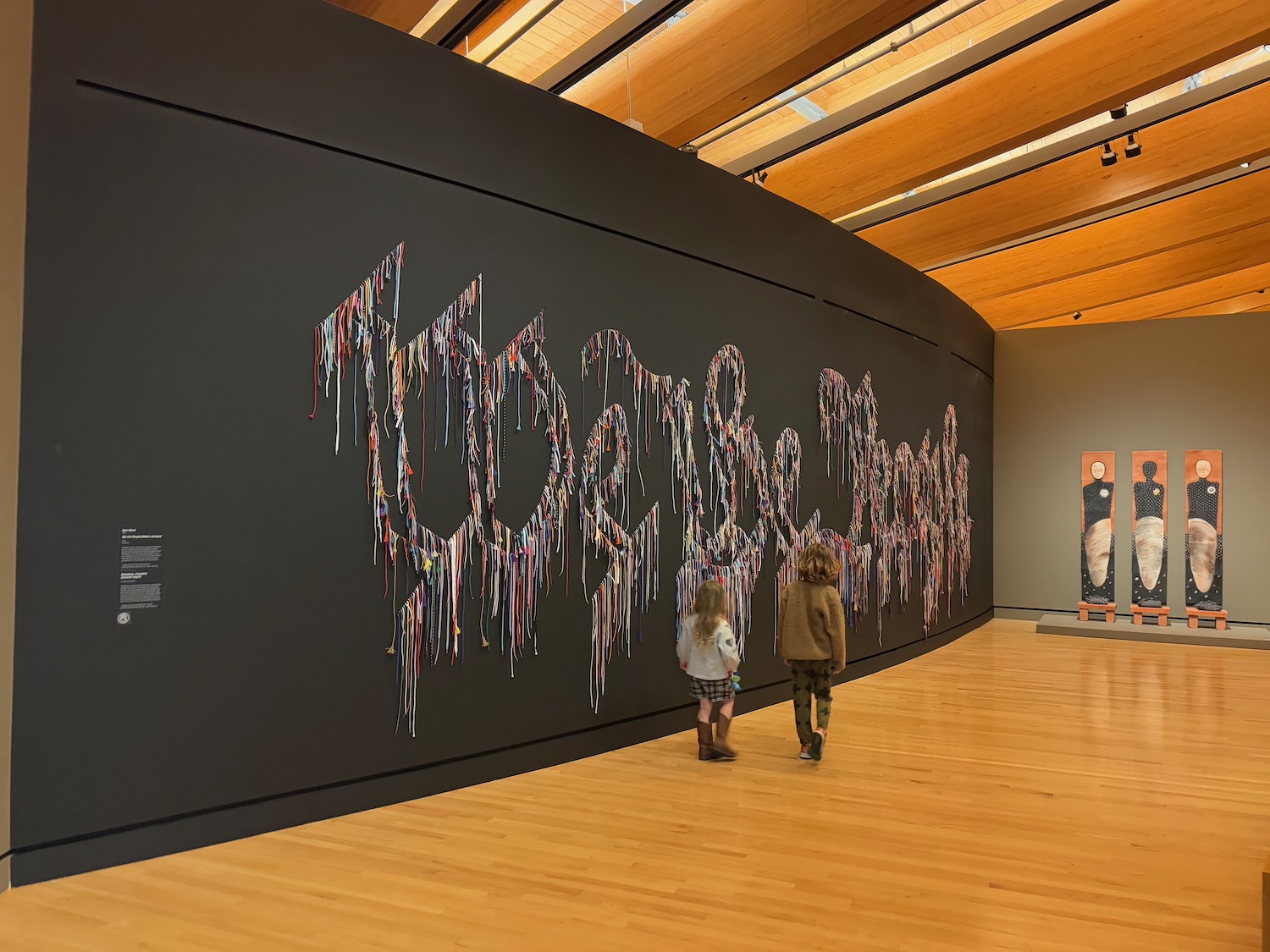 a group of kids walking in a museum