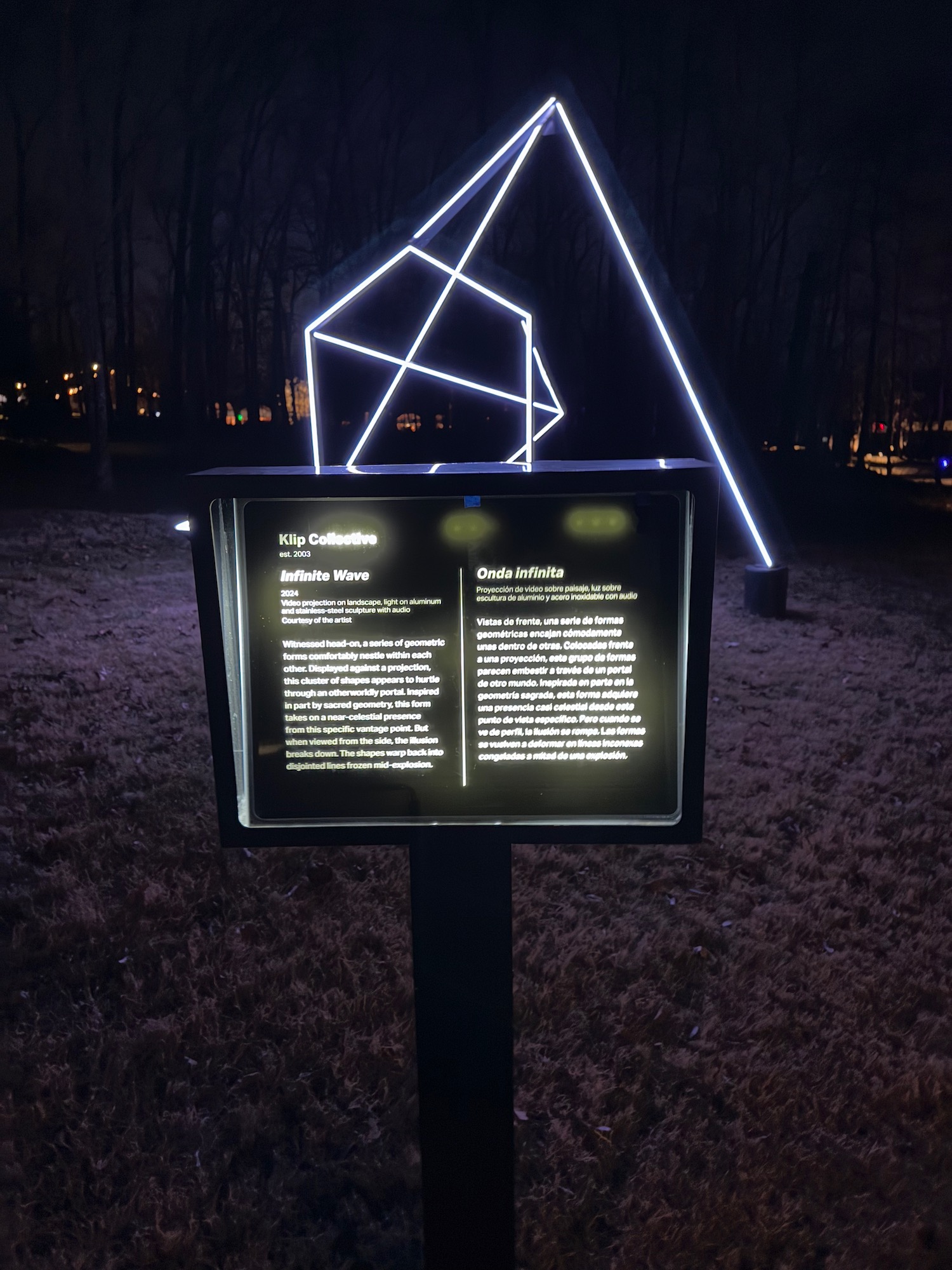 a sign with a lit up triangle and a triangular figure