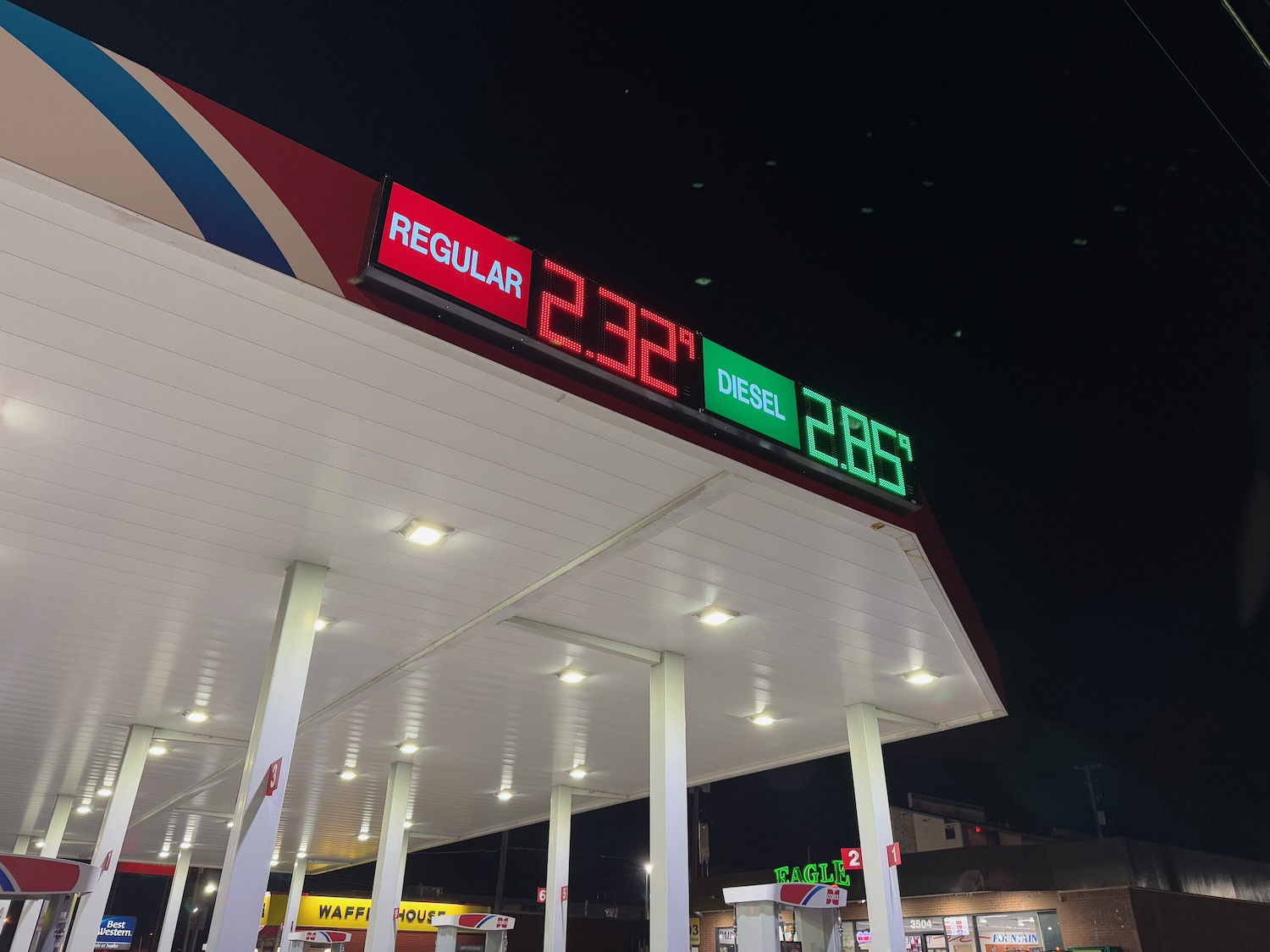 a gas station with a digital sign