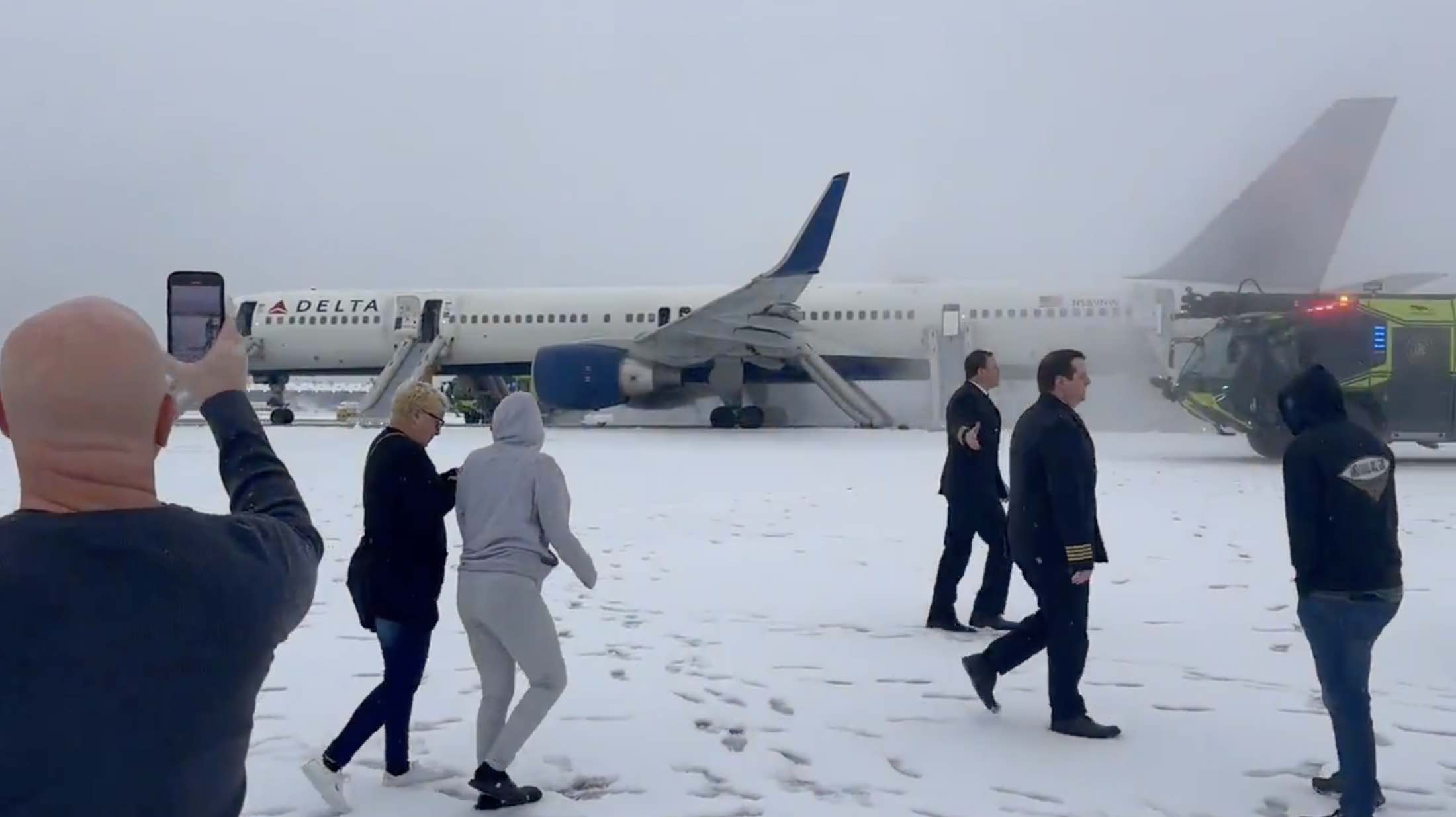 a group of people walking in the snow